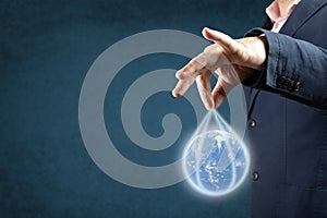 Businessman holds planet earth. corporations run the world globalization concept. blue background. copyspace