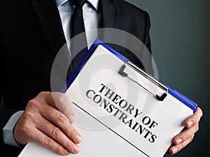 Businessman holds toc theory of constraints papers