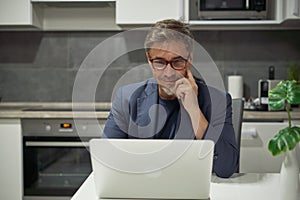 Businessman in home office working with laptop
