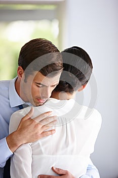 Businessman hug woman for comfort, support and relief at company office. Sad employee and manager help with grief