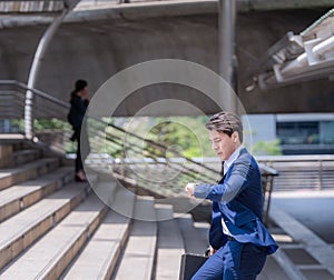 Businessman in a hurry checking time and running, he is late for work his business appointment.