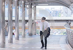 Businessman in a hurry checking time and running, he is late for work his business appointment.