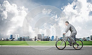 Businessman hurry to work by bike