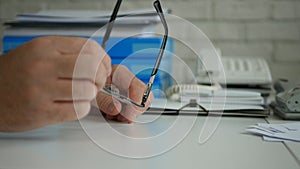 Businessman Image Playing with Glasses on the Table in Office Room