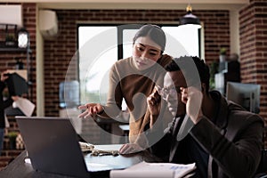 Businessman with impairment analyzing website app on laptop