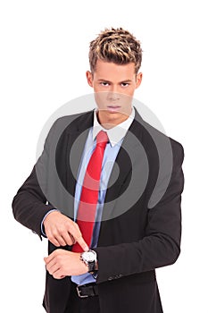 Businessman impatiently pointing to his watc