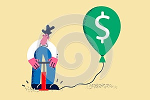 Businessman inflate balloon with dollar sign photo