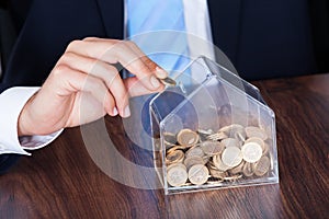 Businessman inserting coin in box