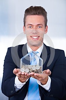 Businessman Inserting Coin In Box