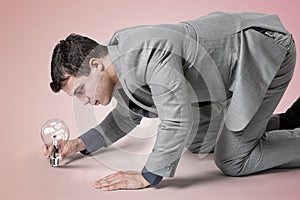 Businessman inside shiny light bulb