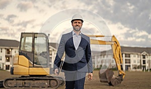 businessman inspect building plan and smile at site. businessman checking building plan