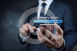 Businessman Installing Software Update on Smartphone photo