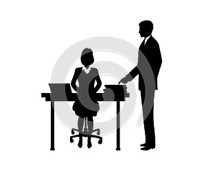 Businessman instructs the secretary sitting at a table.