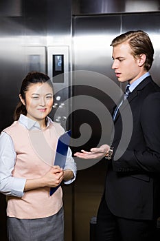 Businessman interacting with businesswoman