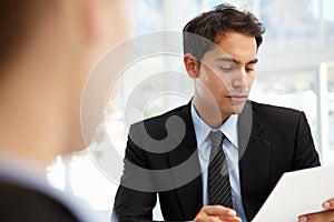 Businessman interviewing female employee