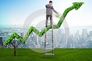 The businessman in investment concept watering financial line chart