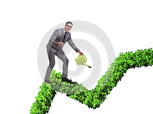 Businessman in investment concept watering financial line chart