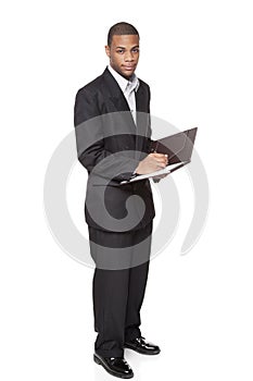 Businessman isolated on white writing on notepad