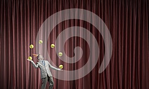 Businessman juggling with balls