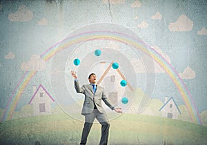 Businessman juggling with balls