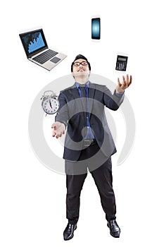Businessman juggling with business items