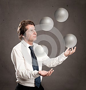 Businessman juggling with crystal sphere balls