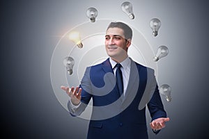 The businessman juggling lightbulbs in new idea concept