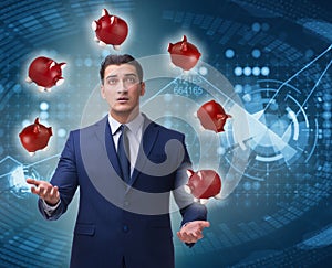 Businessman juggling with piggybanks in business concept