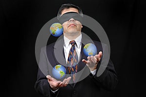 Businessman juggling with planet earth