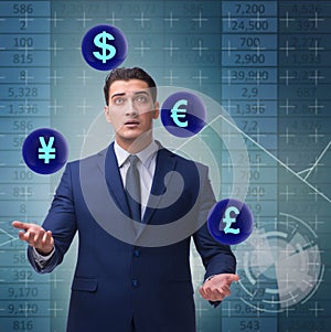 Businessman juggling between various currencies