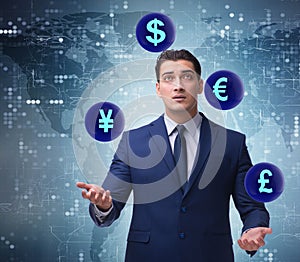 Businessman juggling between various currencies