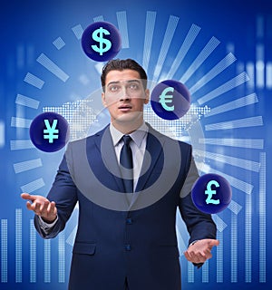 Businessman juggling between various currencies