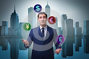 The businessman juggling between various currencies