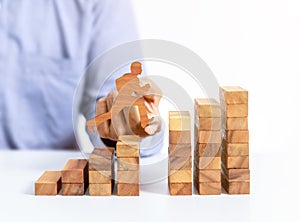 Businessman jump across the gap on wooden block