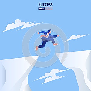Businessman jump through the gap obstacles between hill to success. Business risk and success concept.