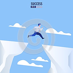 Businessman jump through the gap obstacles between hill to success. Business risk and success concept.