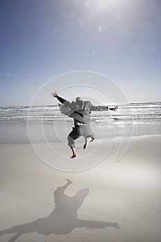 Businessman Jumping On Beach