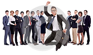 Businessman jumping in front of his team