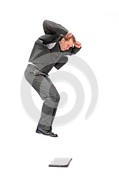 Businessman jumping on the laptop
