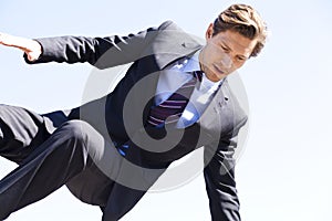 Businessman jumping over something