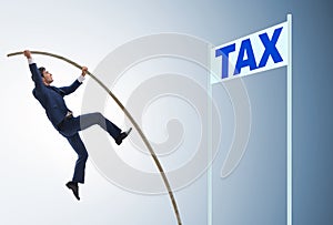 Businessman jumping over tax in tax evasion avoidance concept photo