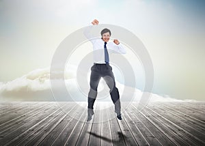 Businessman jumping over wooden boards