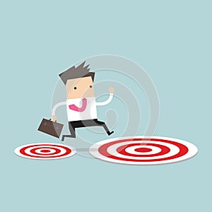 Businessman jumping from small target to the big target