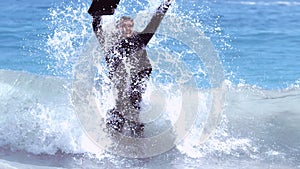 Businessman jumping in the waves