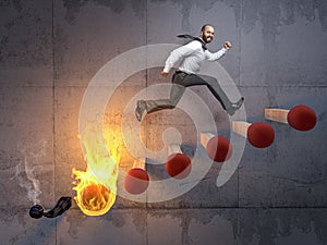 businessman jumps on a stair made of matches