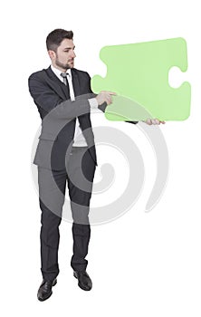 Businessman keeping puzzle piece