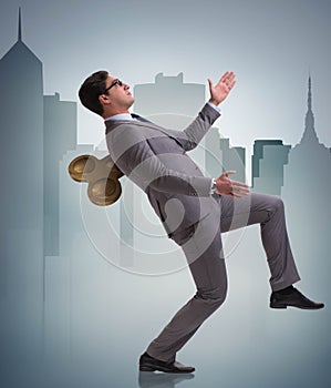 Businessman with key in hardworking concept