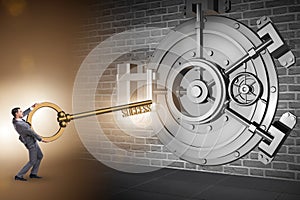 The businessman with key near bank vault door