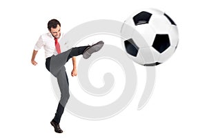 Businessman kicking a football