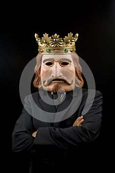 Businessman with king mask and crossed arms